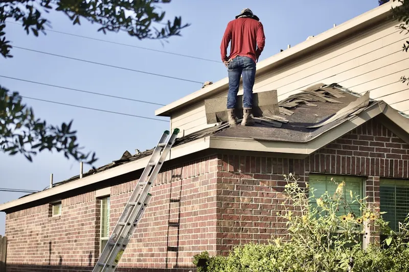 Professional roofer working on a residential roof in Woodhull